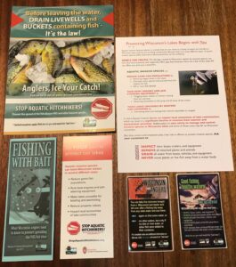 Educational materials for bait shop owners and customers are displayed on a table.