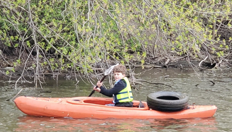 Volunteer in kayak at the Annual Watershed Cleanup