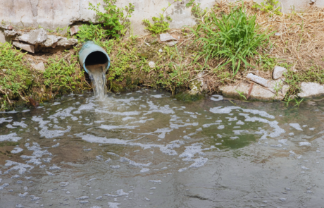 a stormwater outlet pipe draining into a river