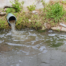 a stormwater outlet pipe draining into a river